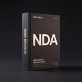 NDA Review Claude skill by KissMySkills, deep charcoal-brown laid paper cover with the monogram NDA